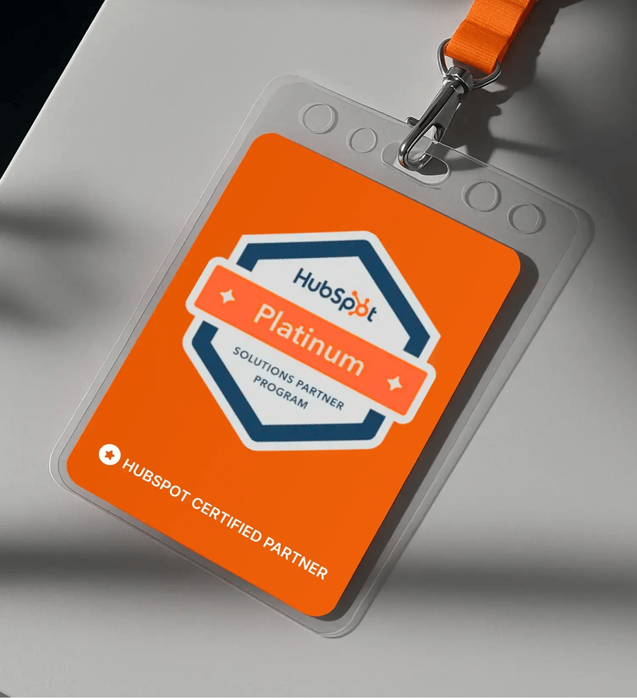 HubSpot Platinum Solutions Partner badge on orange ID card with lanyard showing certified partner program credential